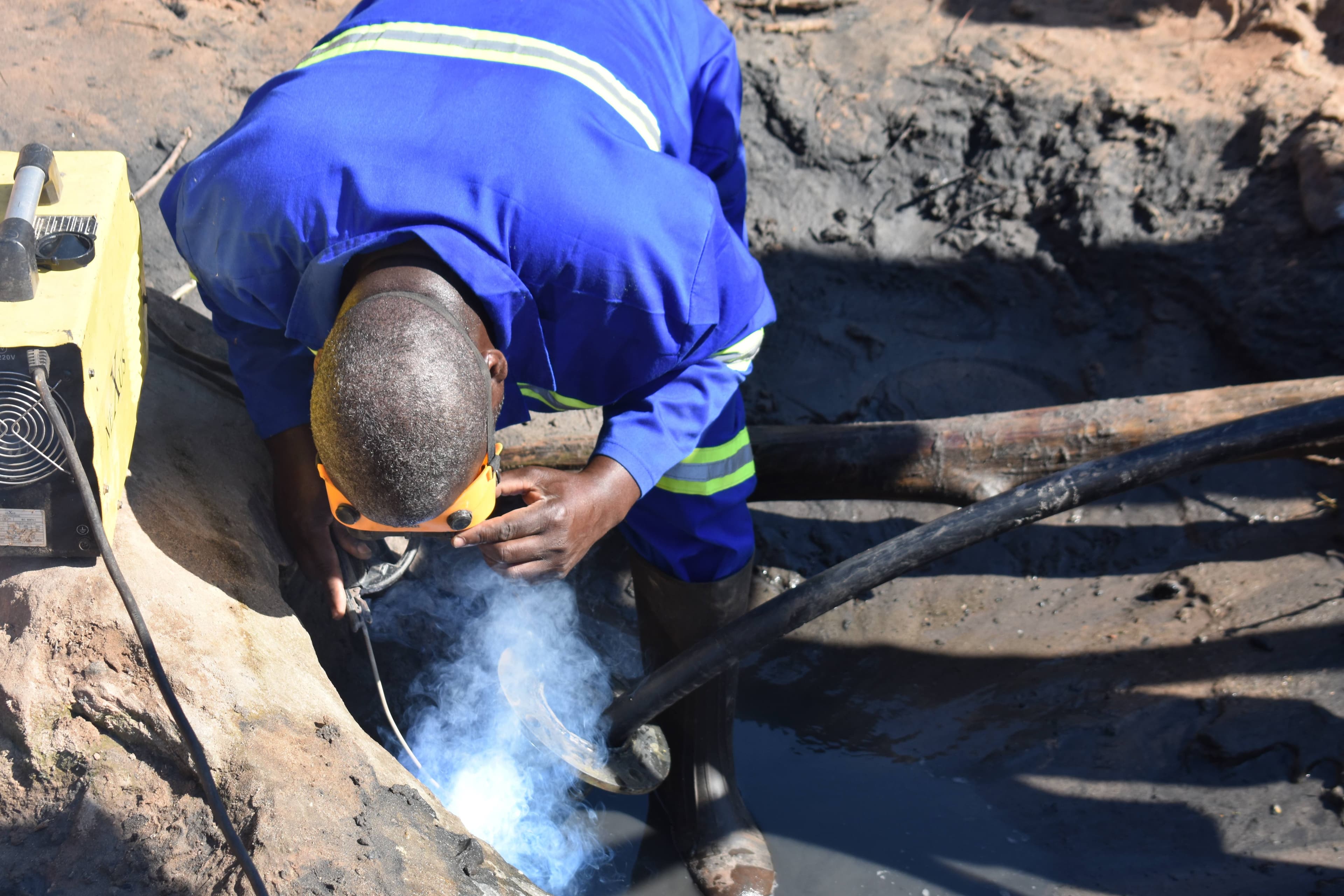 Shamah Engineering technician welding pipes for well rehabilitation